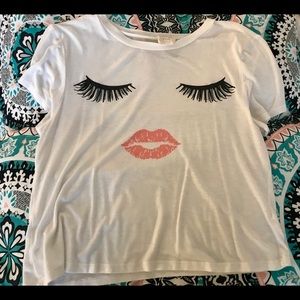 White shirt with two eyelashes and mouth